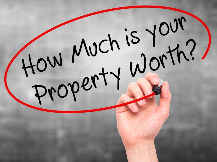 Hand writing 'How Much is your Property Worth?' in red circle.
