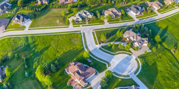 A suburban neighborhood with houses and green lawns.