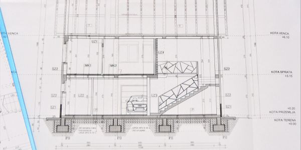 Architectural cross-section drawing of a building with structural and design details.