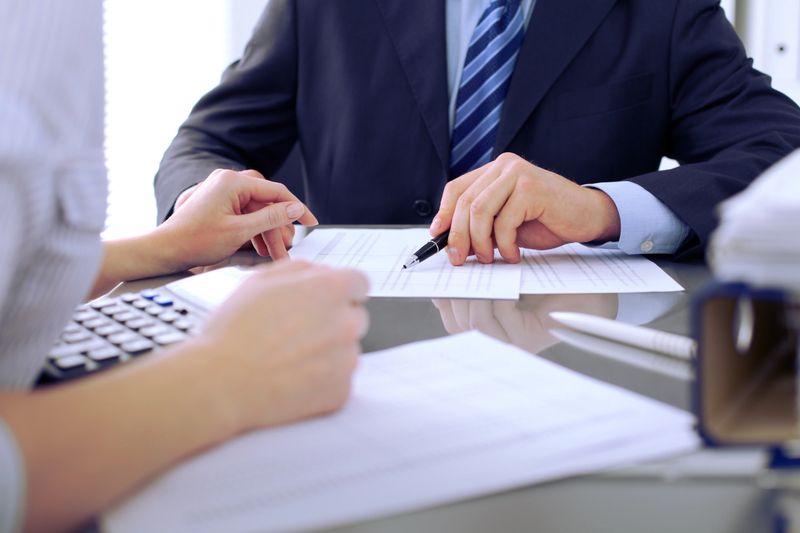 Bookkeepers or financial inspector making report, calculating or checking balance. Audit concept