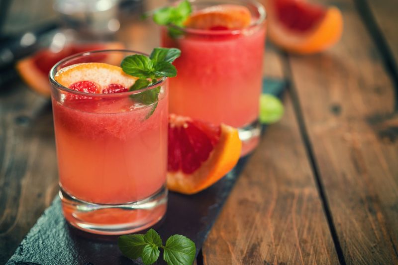 Palomas cocktail combines tequila,mint,fresh grapefruit juice, lime juice,ice,sugar,salt and club soda with a grapefruit wedge.