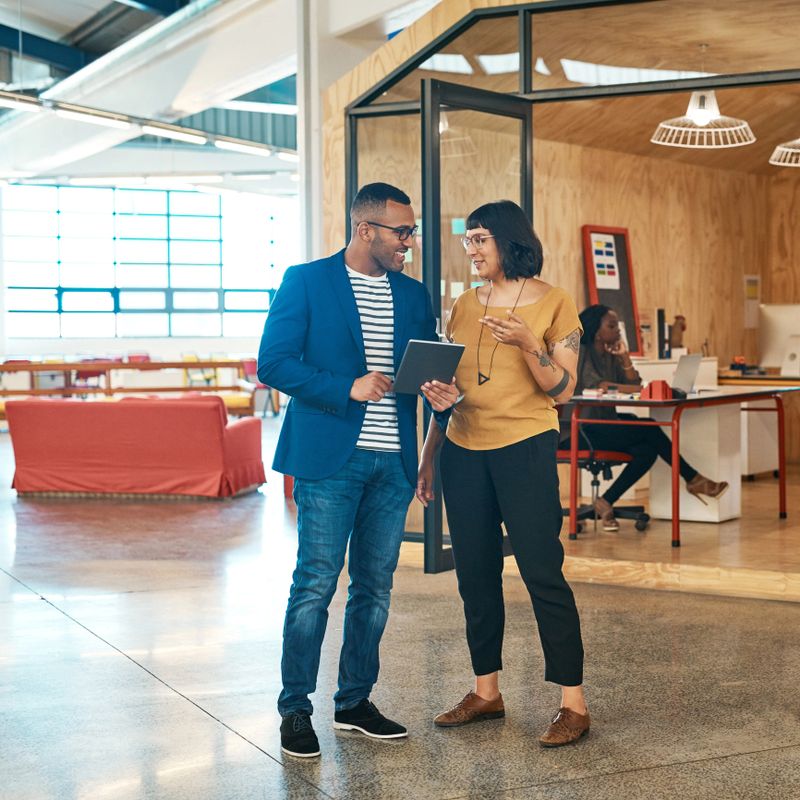 Shot of two young designers working together on a digital tablet in an office