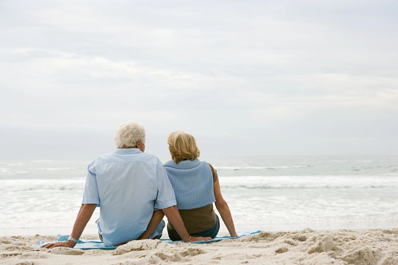 Senior couple sitting on a beach