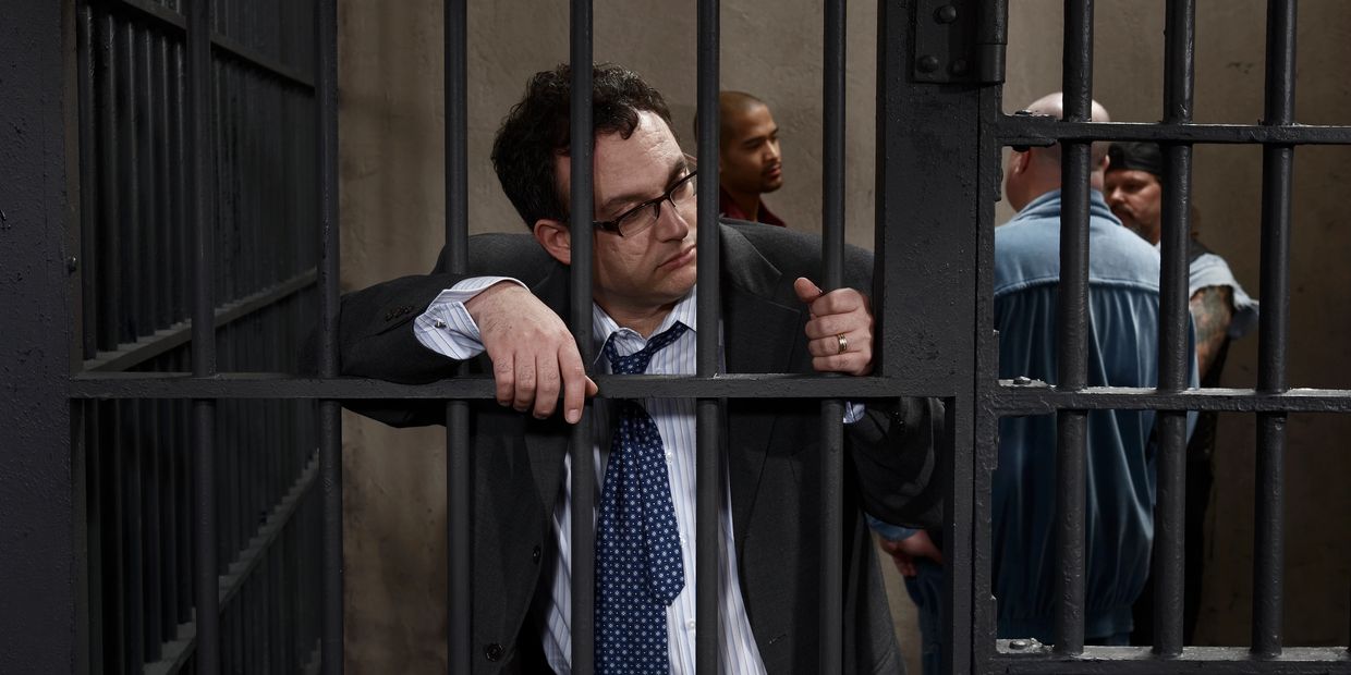 Accused person behind jail bars representing false criminal case, symbolizing filing of quash petiti