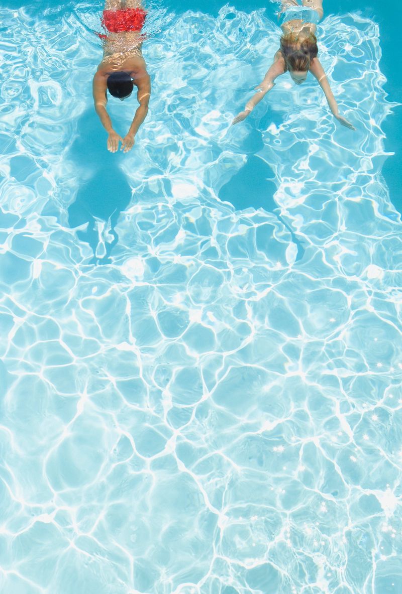 Couple swimming in pool