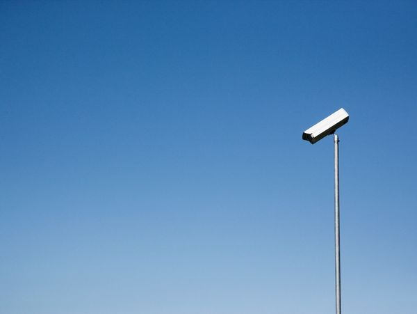 Security camera mounted on a modern building's corner.