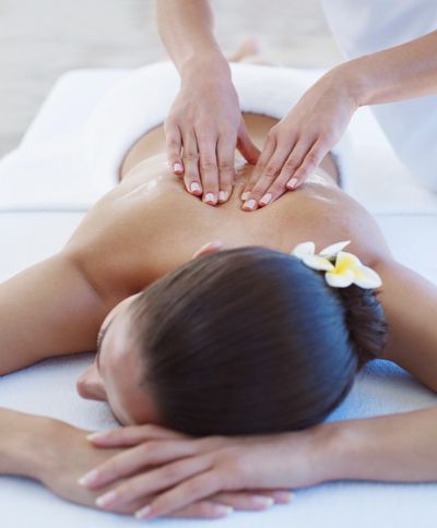 Woman receiving a relaxing back massage at a spa.