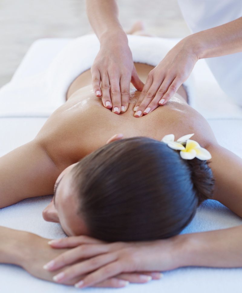 Masseuse giving a woman a back massage