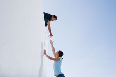 Two people lending a hand to help each other. Community standing together