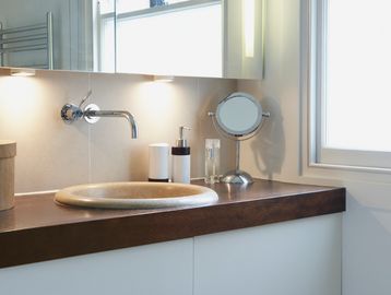 Modern bathroom sink with a wall-mounted faucet.