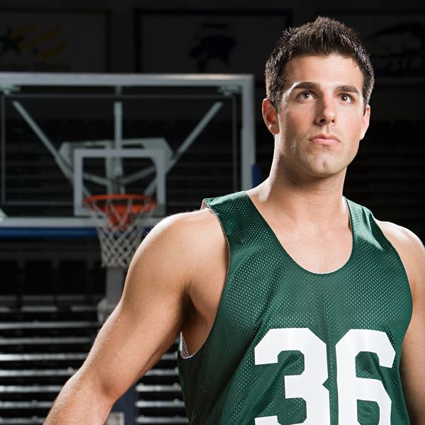 Basketball player in green jersey number 36 on the court.