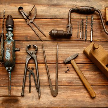 Vintage woodworking tools arranged on a wooden surface.