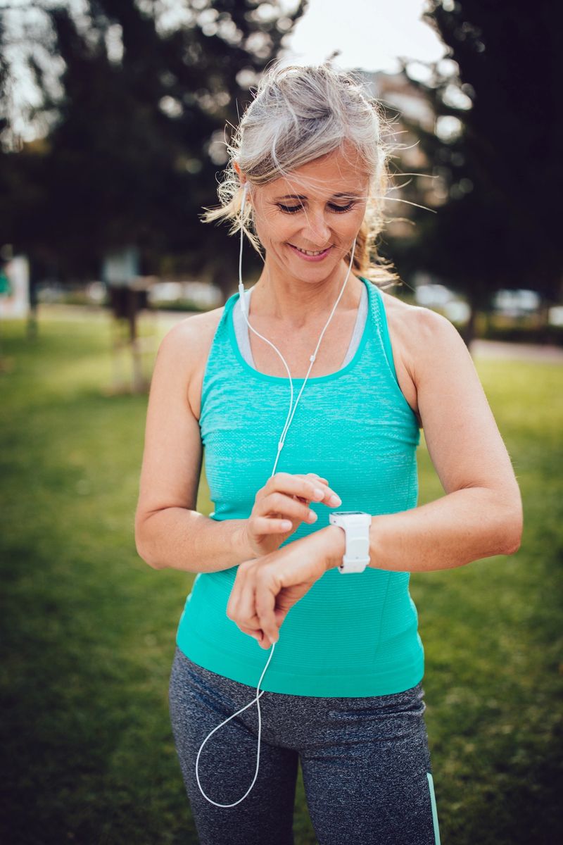 Active senior woman monitoring her running progress on smartwatch