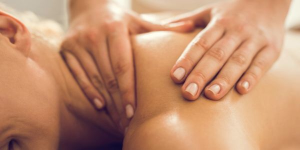 Person receiving a shoulder massage.