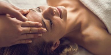 Woman receiving a forehead massage in a spa.
