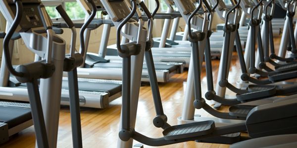 Row of elliptical machines in a gym.
