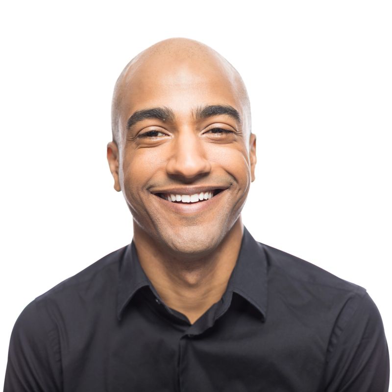 Close up portrait of mature hispanic man standing smiling  white background