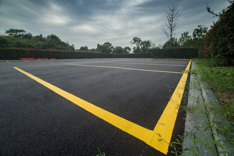 wet parking lot with black asphalt after rain