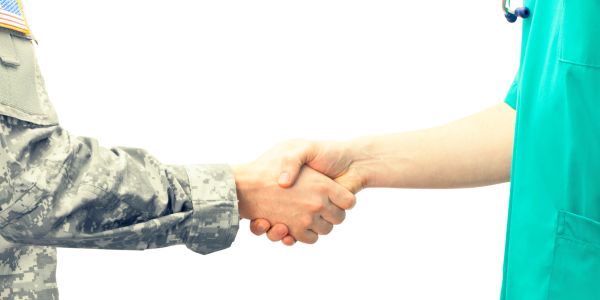 Handshake between a soldier and a healthcare worker.