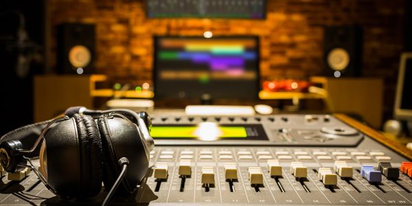 Close-up of headphones on a sound mixing console in a recording studio.