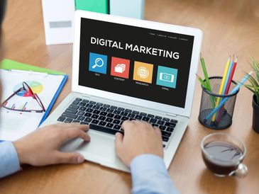 Person working on digital marketing strategies on a laptop at a desk.