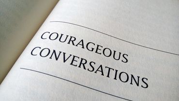 A book page with the title 'COURAGEOUS CONVERSATIONS'.