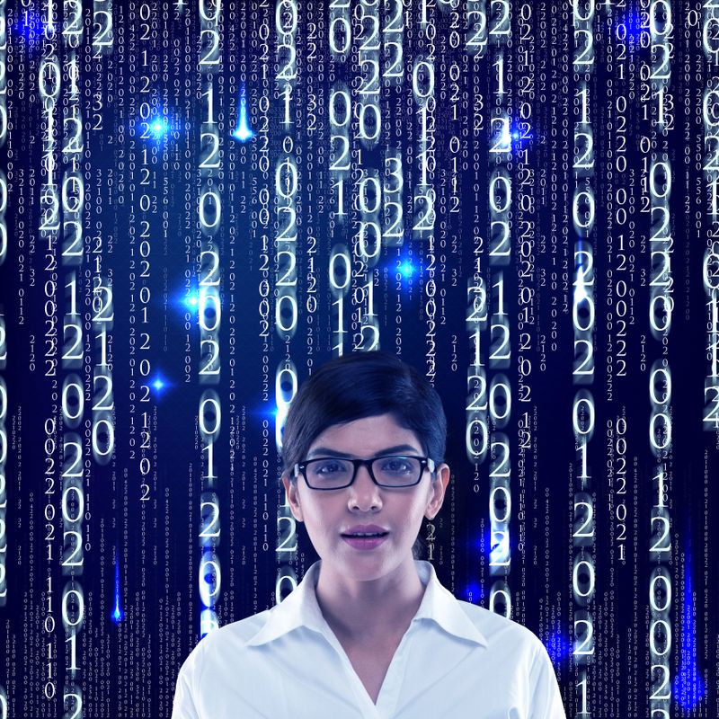 Portrait of businesswoman standing in front of binary code background