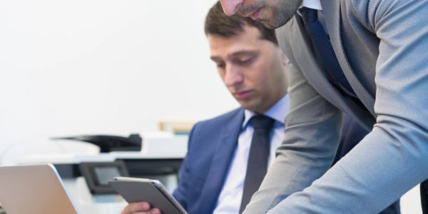 Two businessmen working together in an office setting.