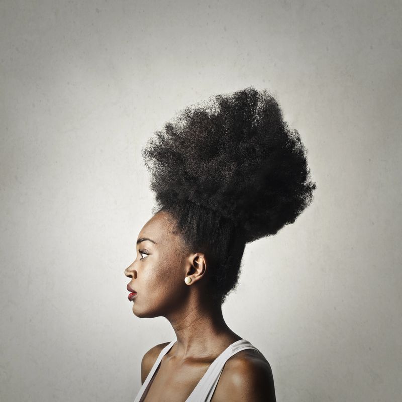 Profile of black woman with a up do coiffure