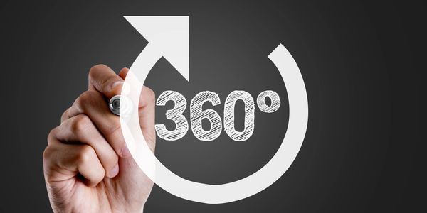 a hand writing the numbers "360" referring to resume writing and interview coaching