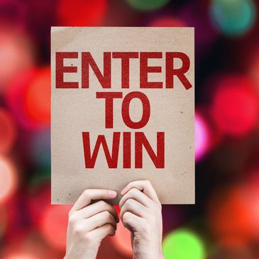 Hands holding a sign that says "ENTER TO WIN".