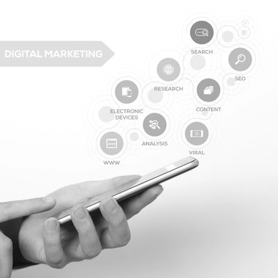Hand holding smartphone with digital marketing icons floating above.