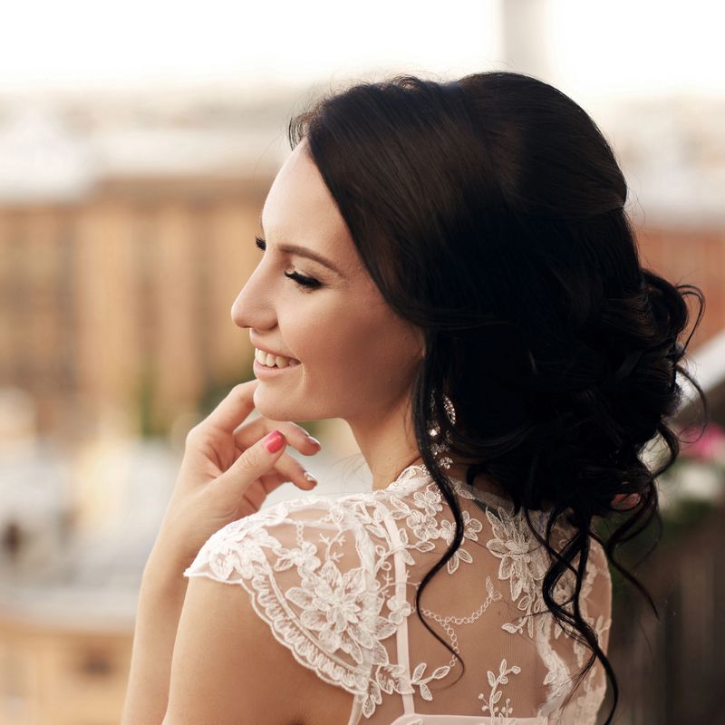 Outdoor summer closeup face portrait of smiling bride at terrace with view on the city