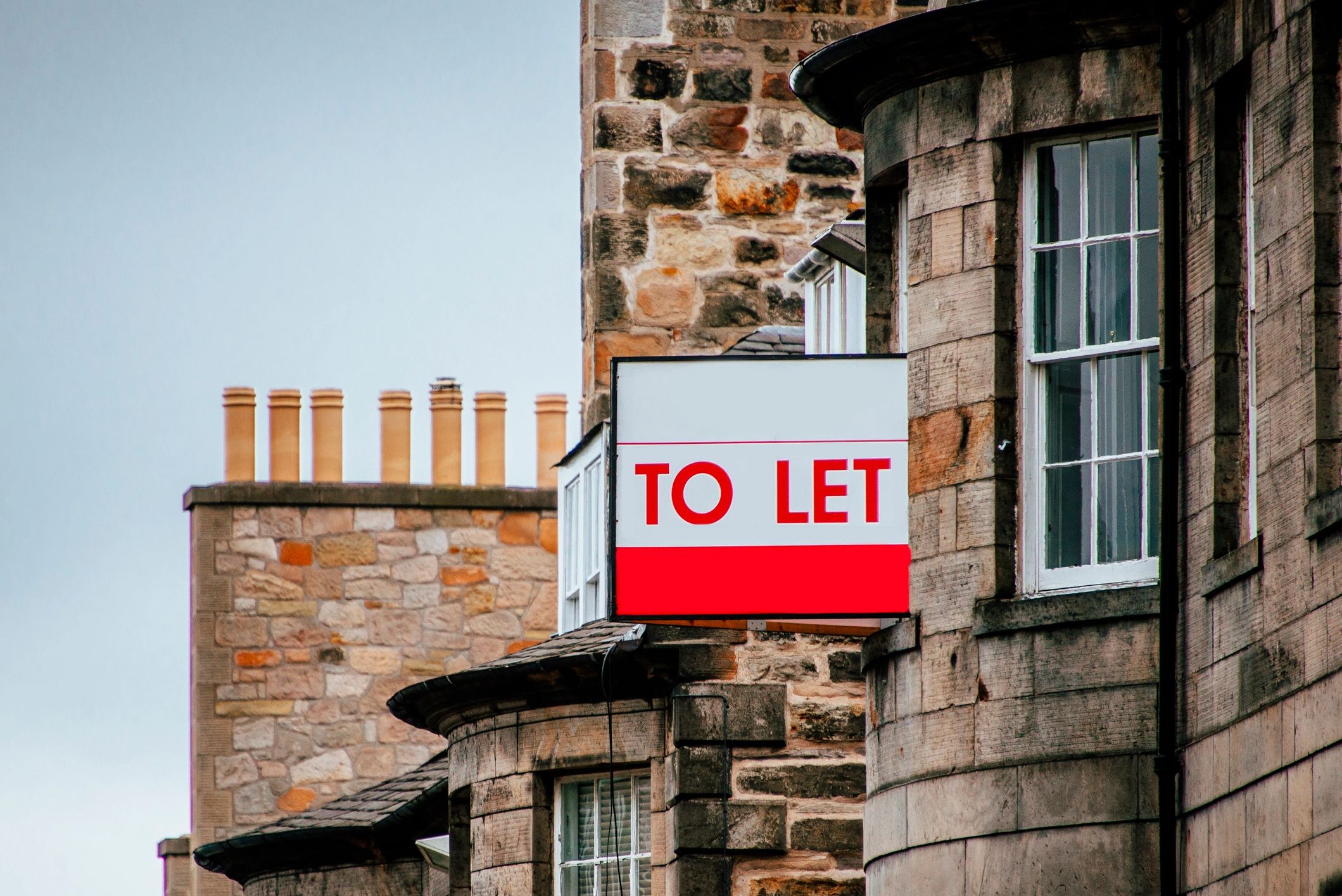 Rental property with a letting agent sign, representing landlord tax returns, rental income reportin