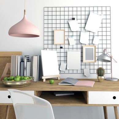 Minimalist workspace with pastel decor and organized notes on a grid board.