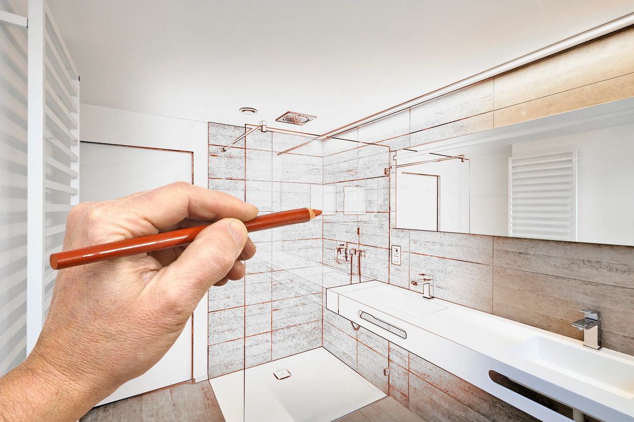 Hand drawing a bathroom design with a pencil.