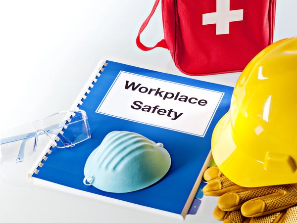 Safety gear and manual for workplace safety essentials.