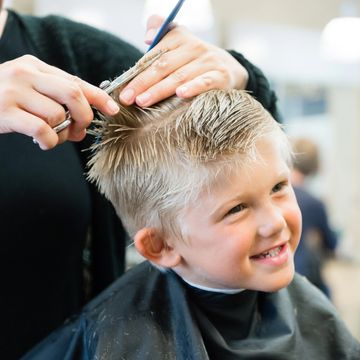little boy getting a haircut
