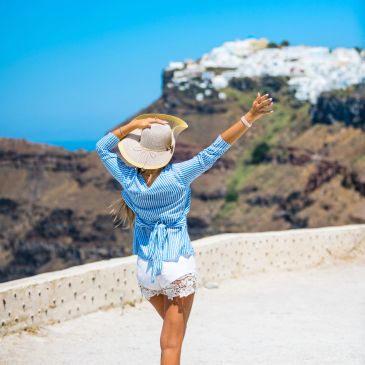 Woman in a hat enjoying a sunny view.