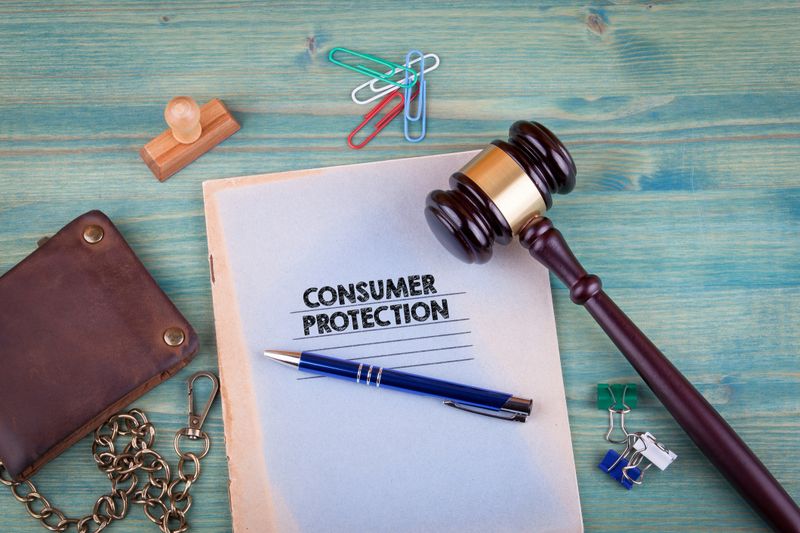 Consumer Protection concept. Notebook on a bright green background. Office stationery accessories