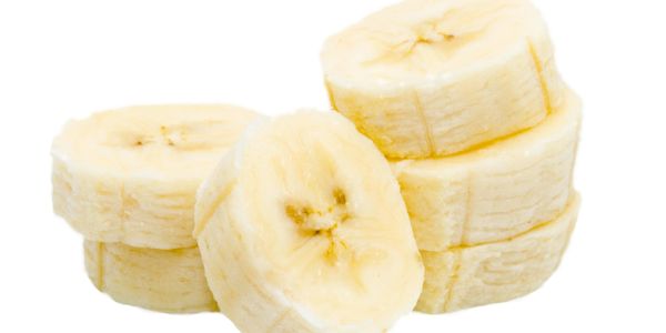 Close-up of sliced banana pieces with a white background.