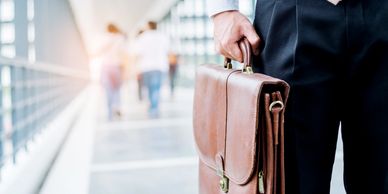 An occupational therapy client holding a briefcase, representing graduated return to work planning