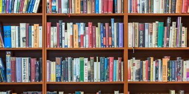 Shelves packed with various books in a library.