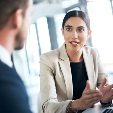 Businesswoman explaining a point during a meeting.