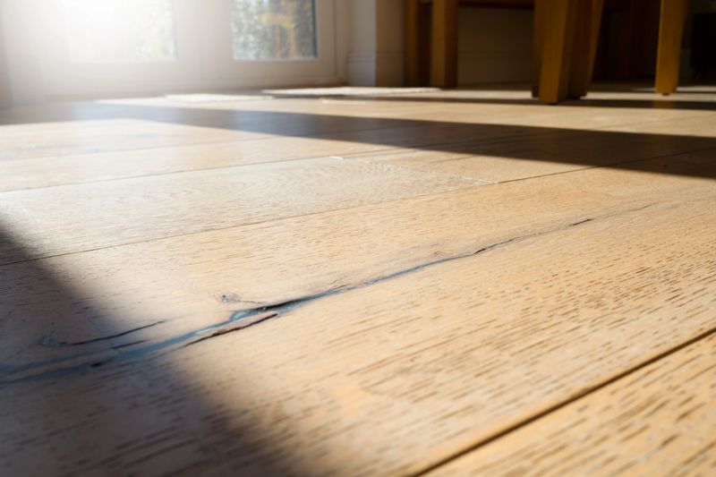 Textured Oak wood flooring in domestic setting with sunlight and shadows.