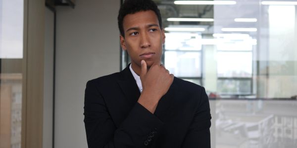 Thoughtful man in a suit indoors.