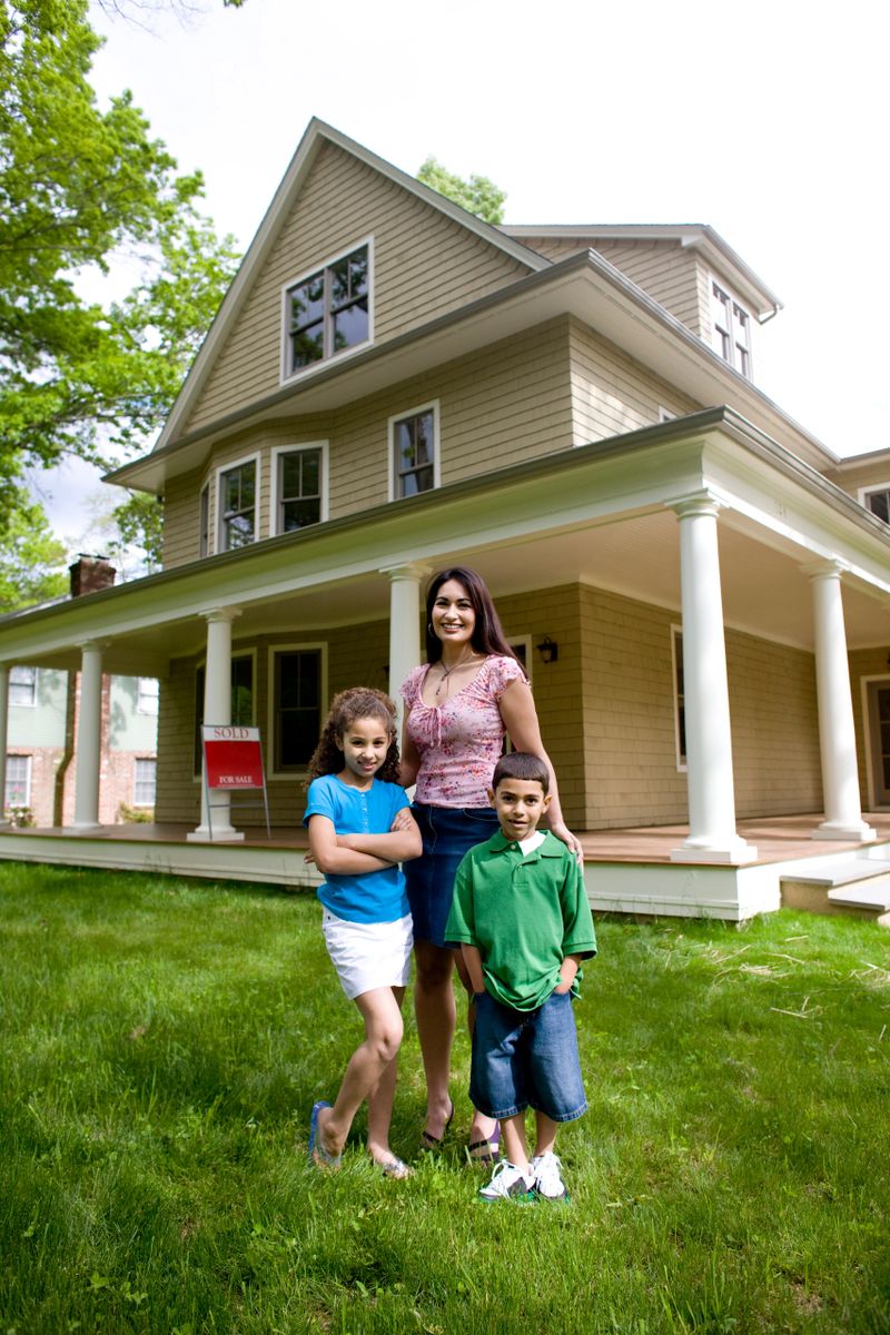 Sold sign on porch in background