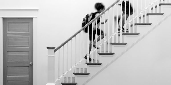 Children running up a staircase 