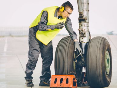 Man checking an aircraft tire 