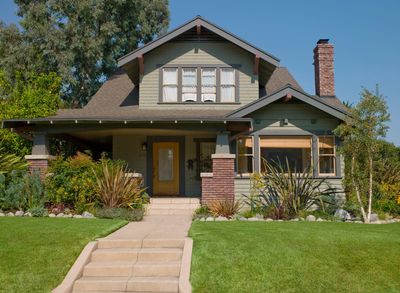 Classic craftsman style house with a well-kept lawn.